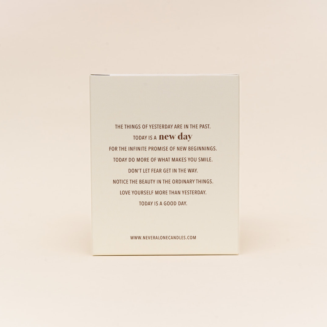 A candle box with inspirational message about embracing every new day in life.