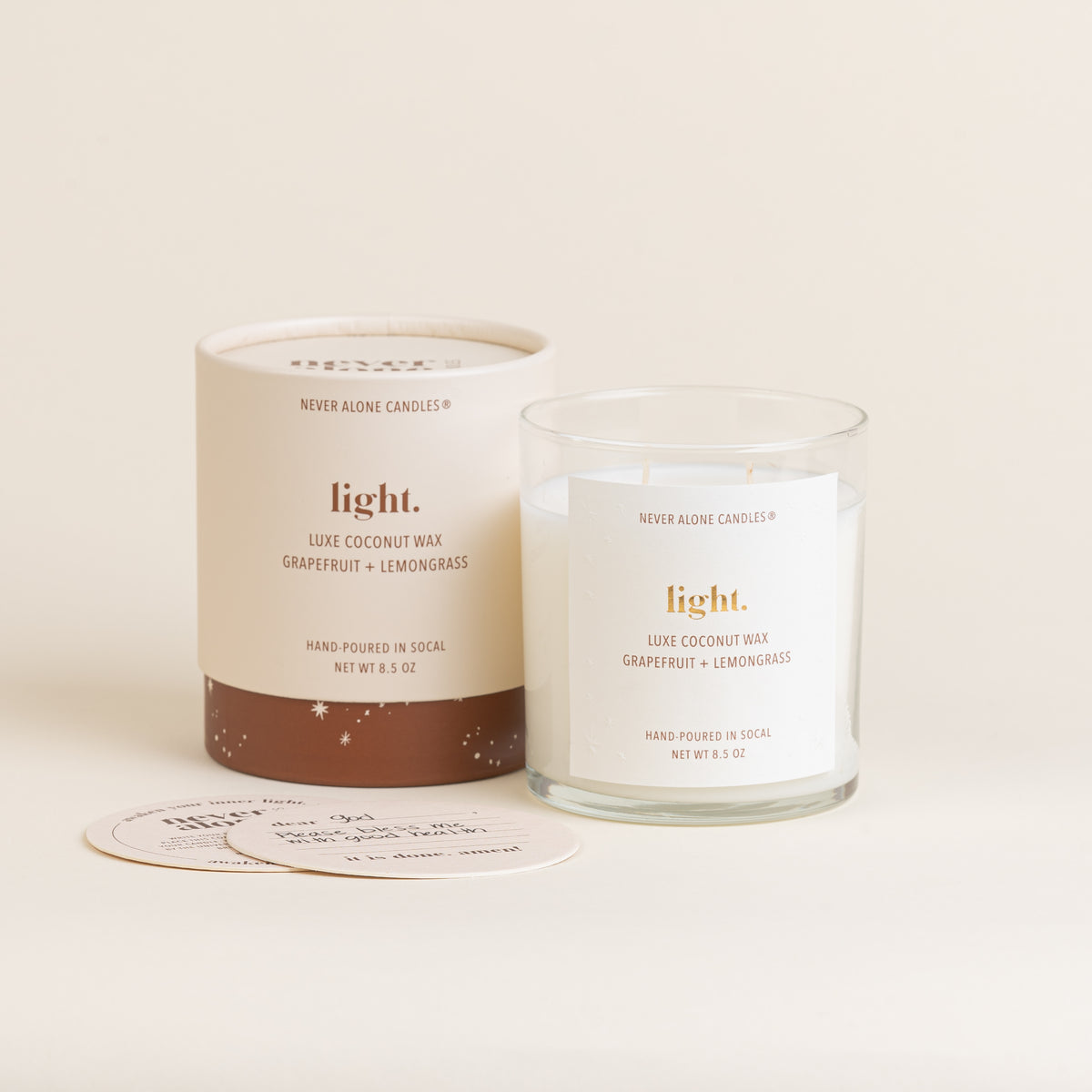 A hand poured prayer candle scented with grapefruit and lemongrass and coasters