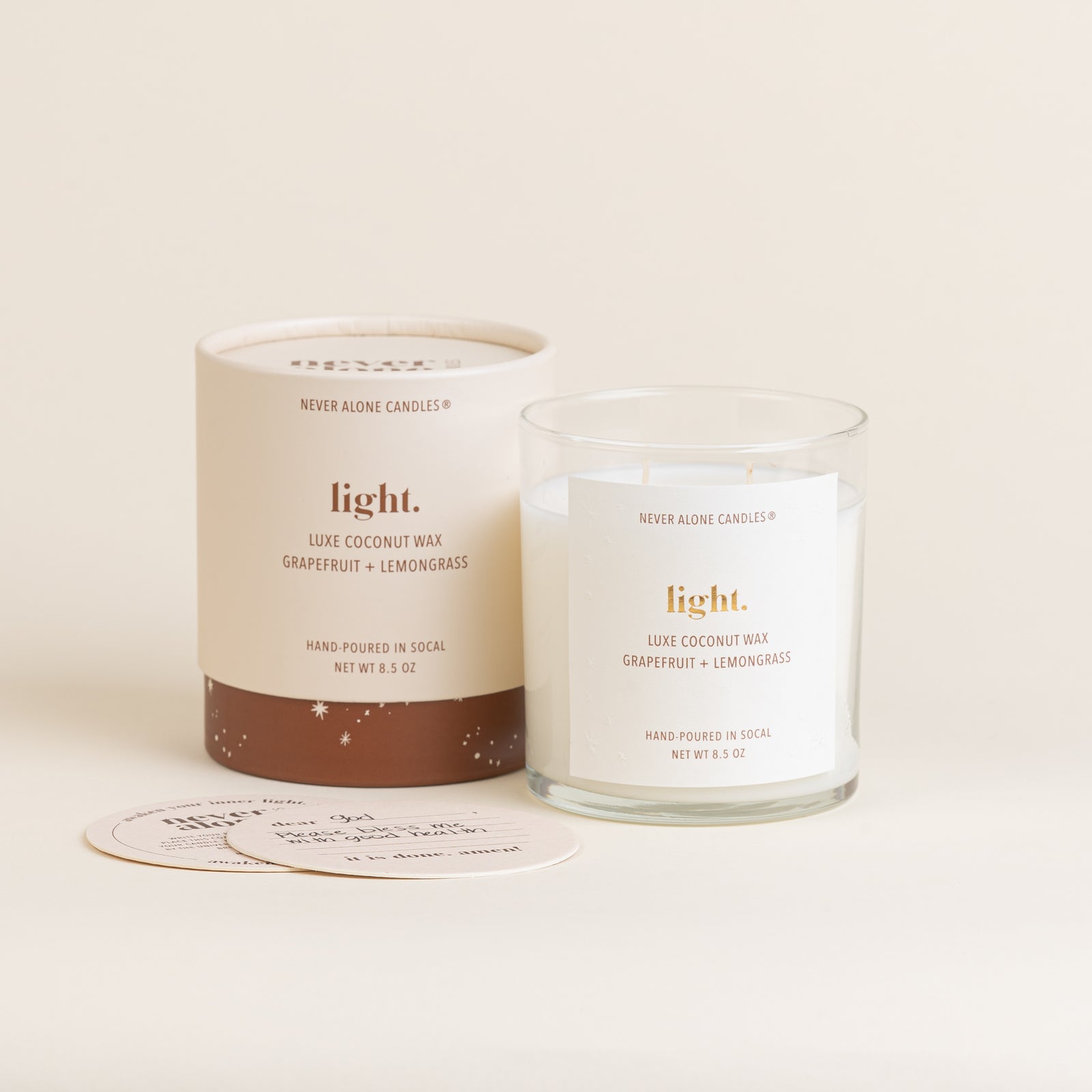 A hand poured prayer candle scented with grapefruit and lemongrass and coasters