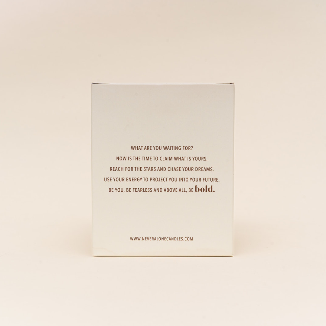 A candle box with an inspiring message about being bold in life.