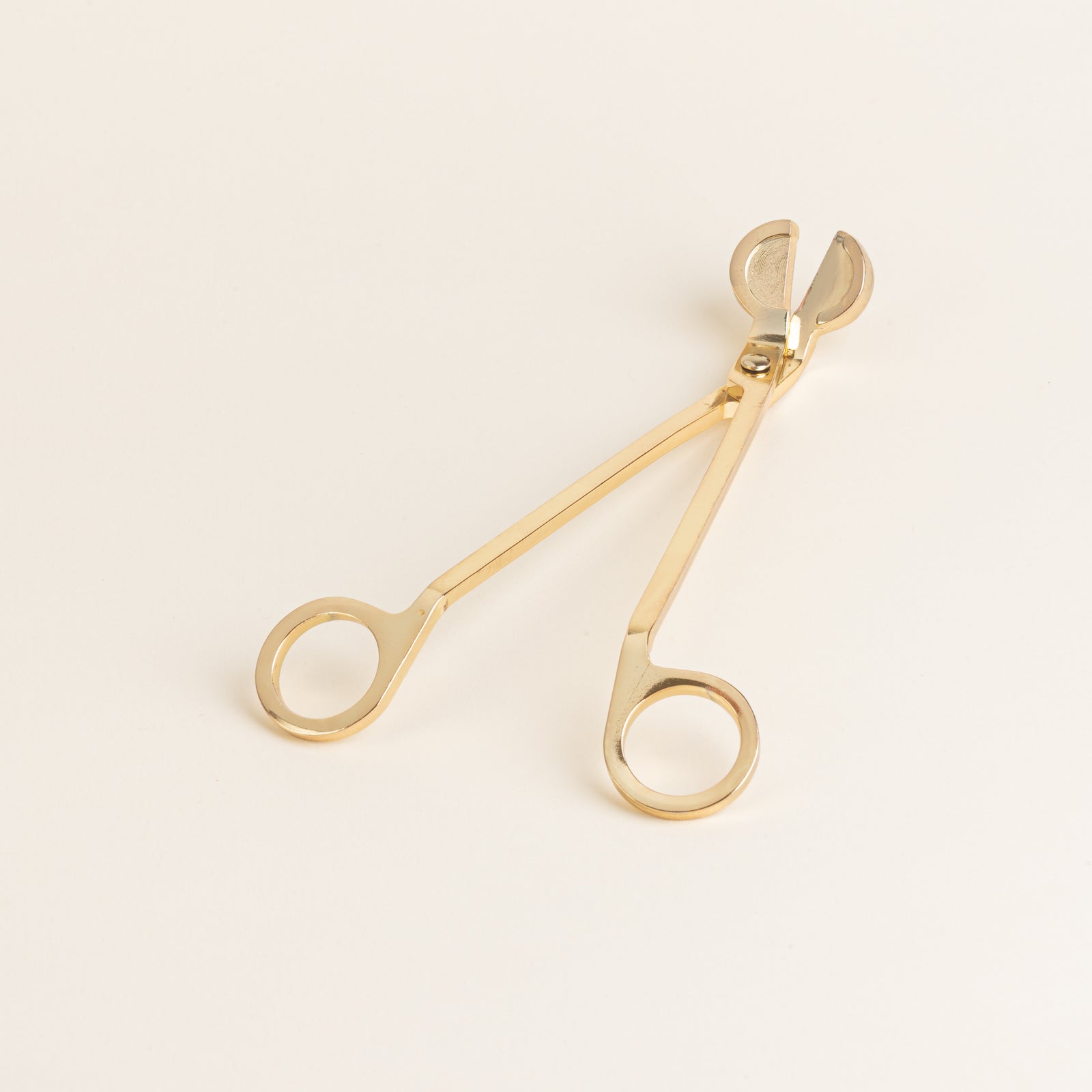 gold wick cutter engraved with Never Alone Candles