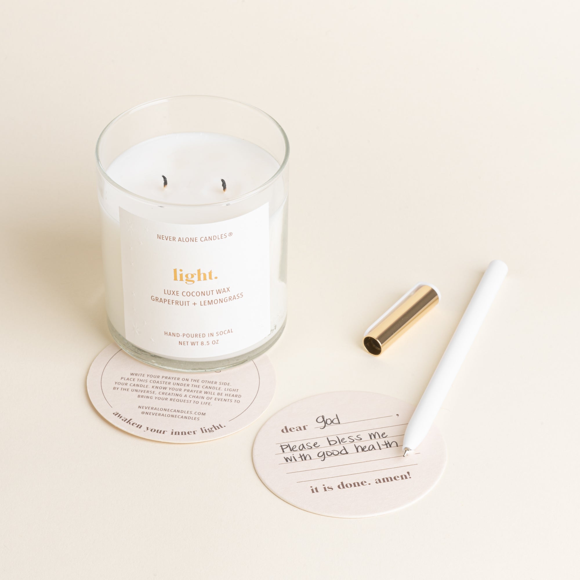 A hand poured prayer candle scented with grapefruit and lemongrass and coasters 