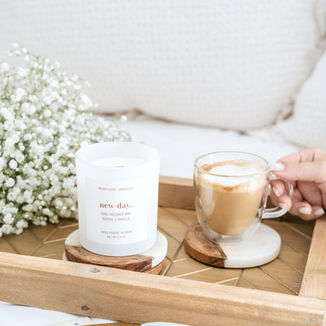 New Day coffee vanilla candle styled in a cozy home setting